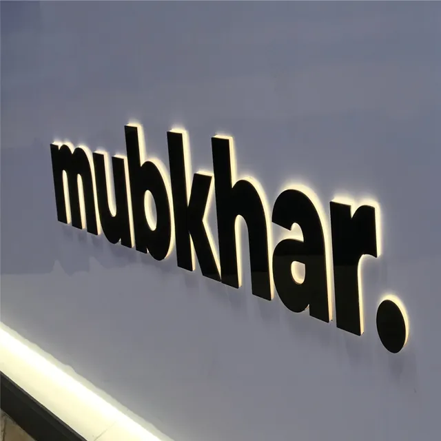 Duvarda arkadan (halo) aydınlatmalı siyah kutu harf logo